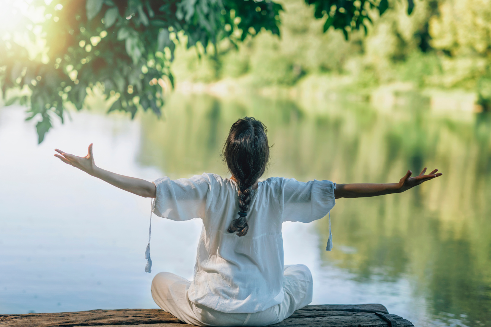 Self-Discovery Meditation In Nature By The Lake. Woman Sitting In Lotus Position Meditating